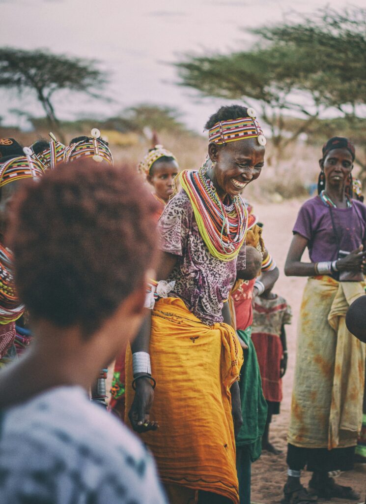 A tribe elder performing a cultural dance with others