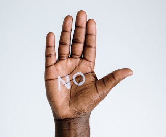 Man's palm up A raised hand with the word 'no' written on the palm