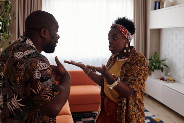 A couple with frustrated faces having a tense interaction
